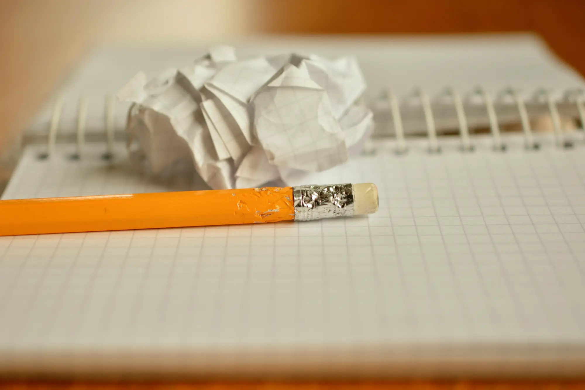 Pencil, notebook and crumpled paper