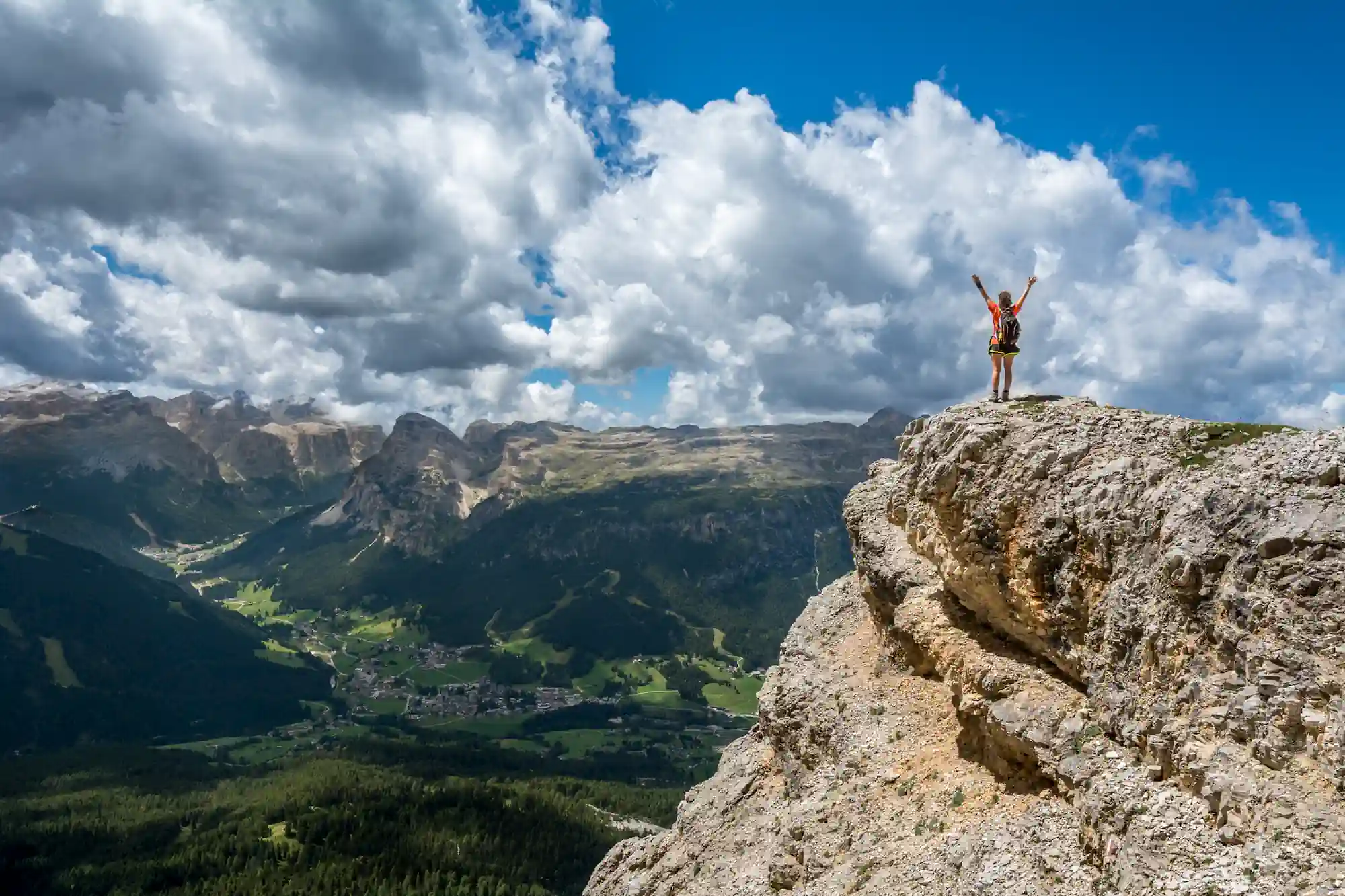 Woman celebrating on top of a mountain