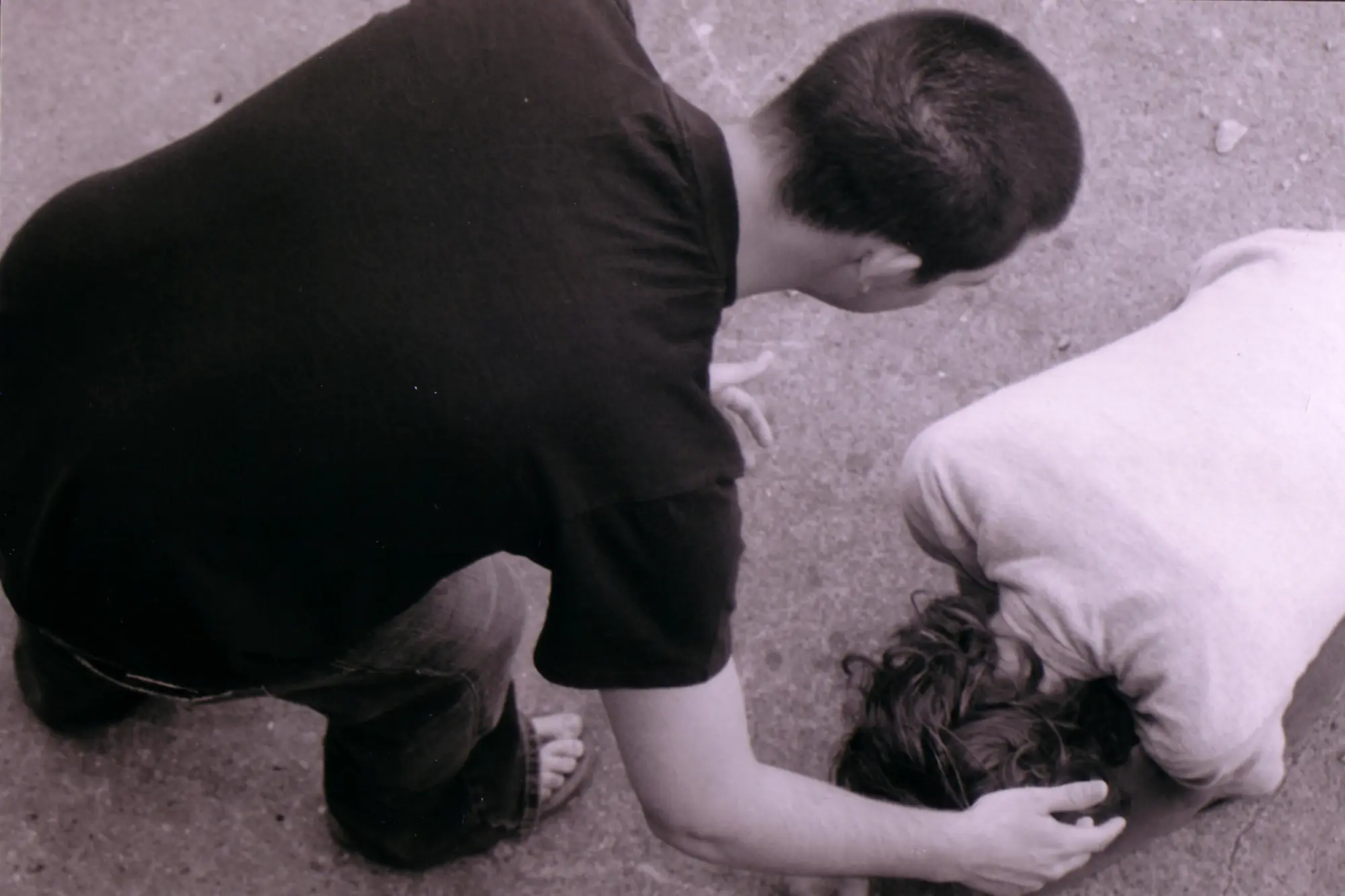 Good Samaritan praying for woman on her knees