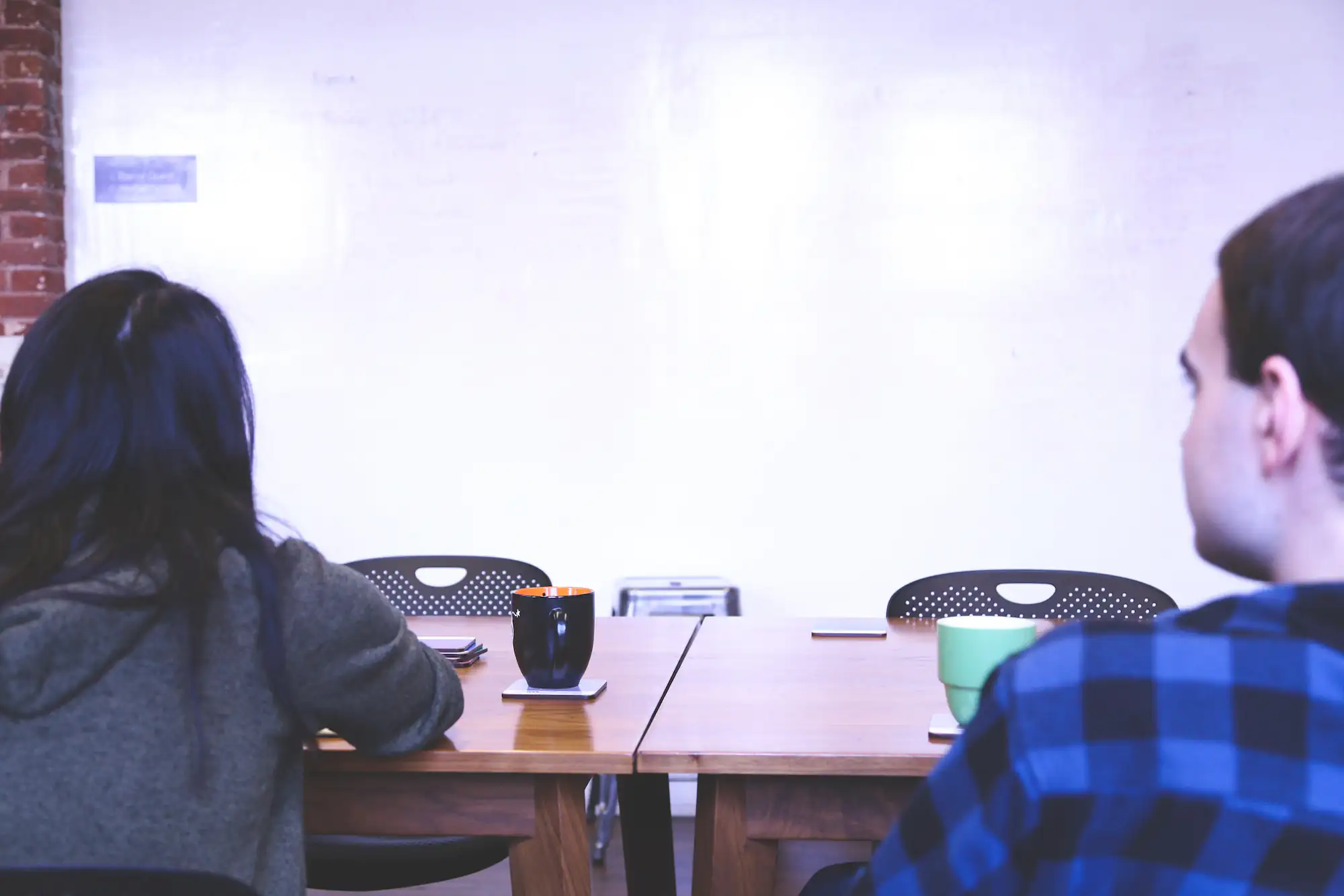 Two people looking at a whiteboard